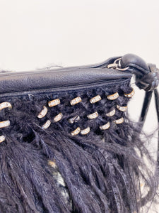 Clutch bag with feathers